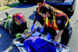 Emergency Medical Responder EMR course participant performing advanced patient assessment during hands-on training at Aspire First Aid in Mississauga